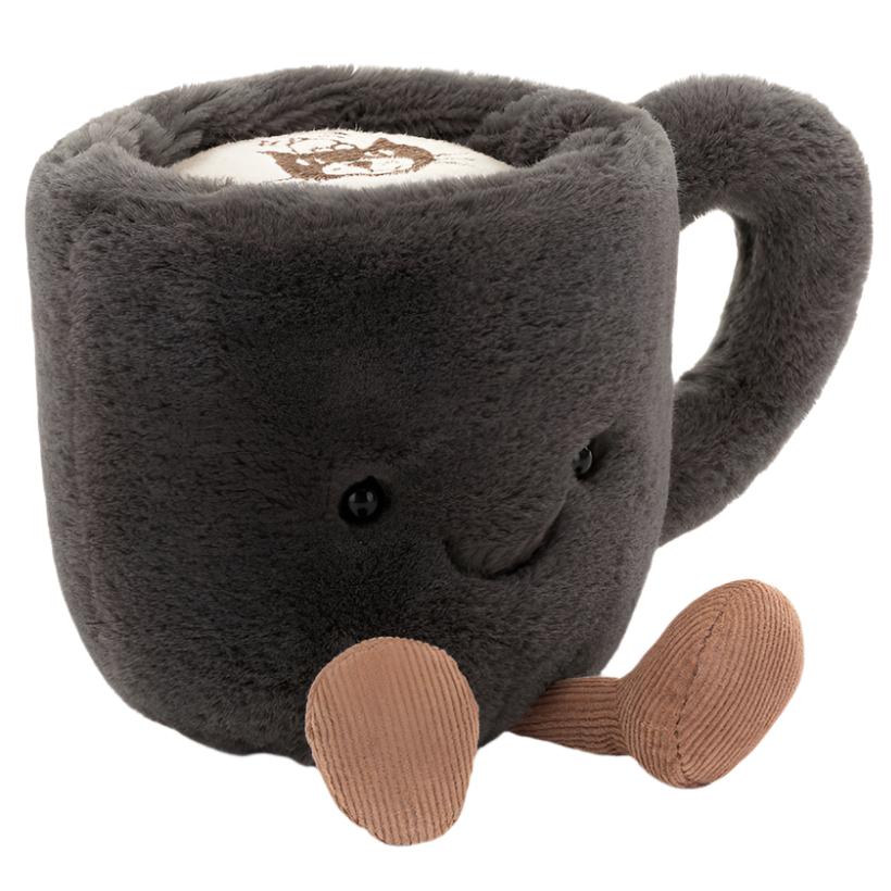 Introducing the Jellycat Amuseables Coffee Cup, a plush toy exuding quirky charm with its gray mug shape, smiling face, brown legs, and textured handle. Resembling a coffee cup with foam on top, this delightful companion from Jellycat adds a cozy vibe to any room.