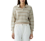 A woman stands facing forward, wearing the Guest in Residence Collegiate Stripe Polo tucked into high-waisted white pants.