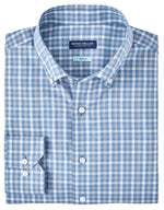 The Peter Millar Combe Cotton Sport Shirt in a blue and white checkered pattern is designed with a button-down collar and buttoned cuffs, expertly crafted from cotton yarn and neatly folded.