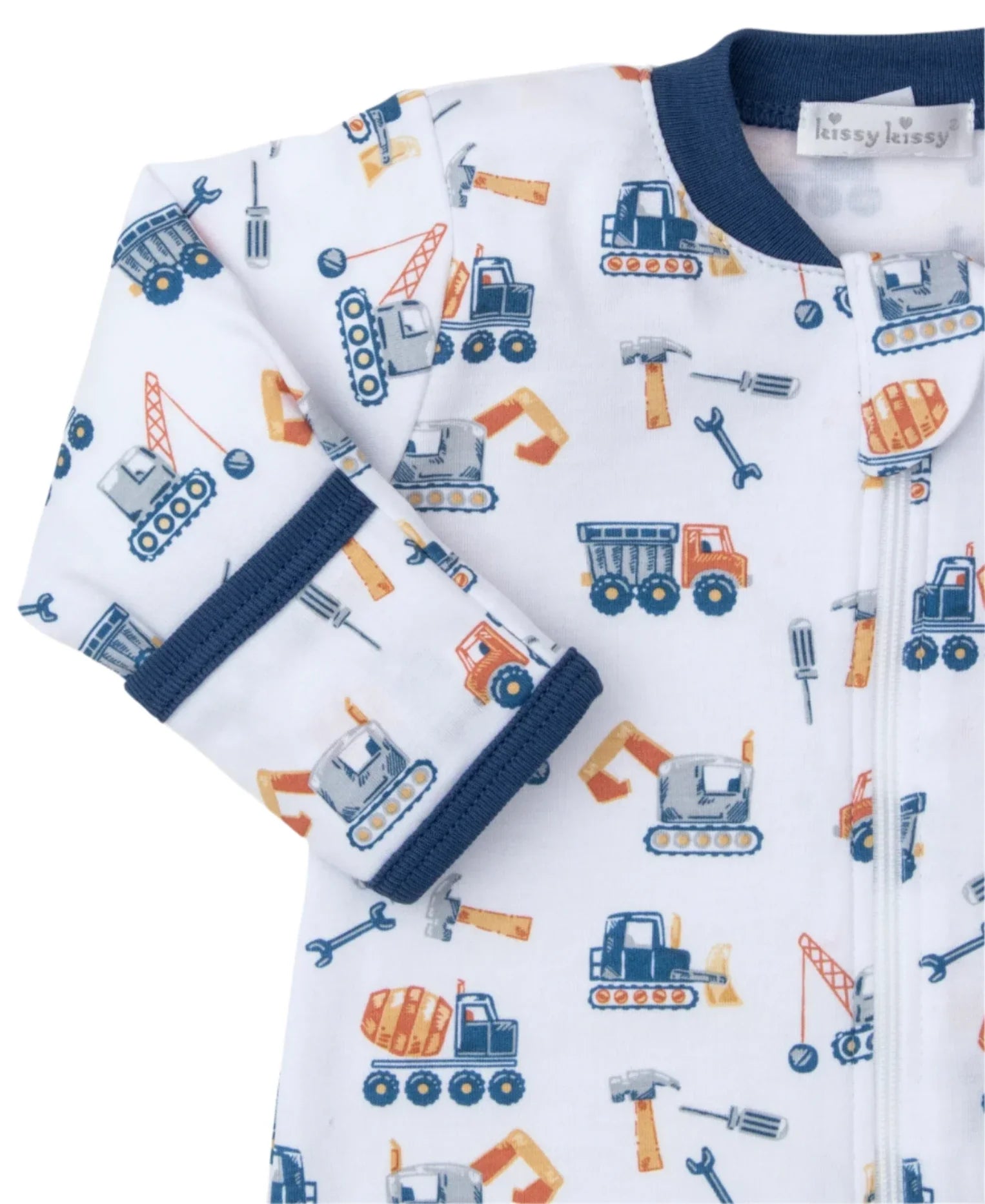 The Kissy Kissy Construction Crew Zip Footie by Kissy Kissy is a white baby onesie with blue trim, crafted from soft Pima cotton and adorned with a pattern of construction vehicles and tools.