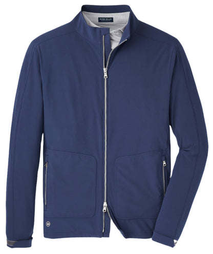 Introducing the Peter Millar Contour Jacket by Peter Millar: A navy blue, water-resistant jacket featuring a stand collar, two zippered side pockets, and a small logo on the bottom left. This stylish piece is designed with men's tailored fit and grey interior lining, offering four-way stretch for ultimate comfort.