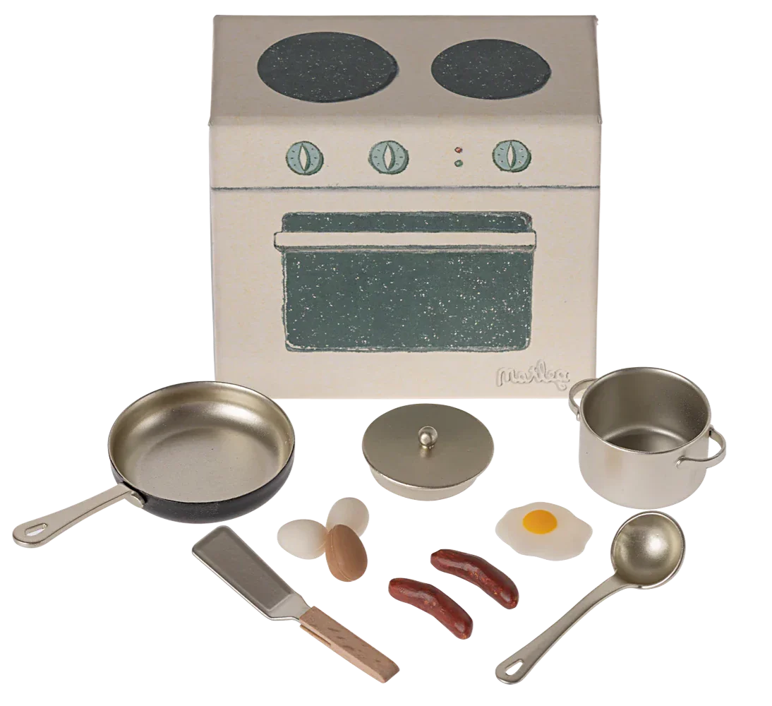 Introducing the Maileg Cooking Set, Mouse by Maileg: a delightful toy kitchen set that includes a stove, frying pan, saucepan, kitchen utensils, frying egg, sausages, and other food items. This charming small kitchen set is the perfect playset for kids to engage in imaginative culinary fun!