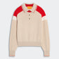 The Alpine Collegiate Polo by Guest in Residence is a beige women’s cashmere sweater featuring red and white color block on the shoulders and collar, long sleeves, and a three-button placket—ideal for elevating your casual style.