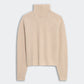 Guest in Residence Cropped Ribbed Turtleneck in beige cashmere, featuring long sleeves and a ribbed knit, displayed flat on a light background.