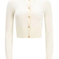The Arlette Sweater by Altuzarra is a long-sleeve, white ribbed knit cardigan with two-tone metal buttons and a round neckline, shown on a plain background.
