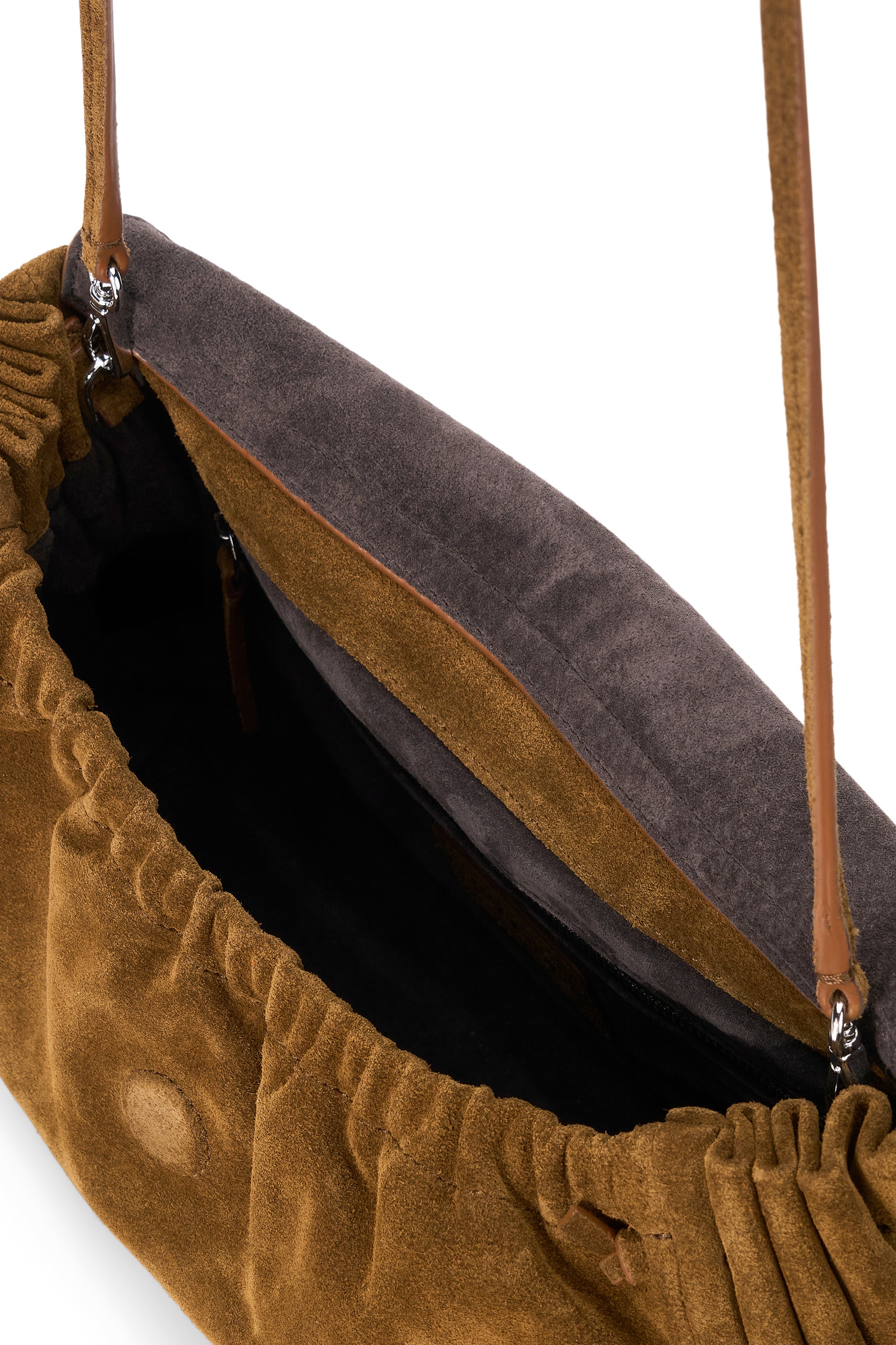 Close-up view of an open Staud Cy Convertible Bag in brown suede with a single strap, revealing the inner lining and spacious interior. This versatile piece effortlessly transitions from a chic crossbody to an elegant handheld accessory, making it ideal for any occasion.