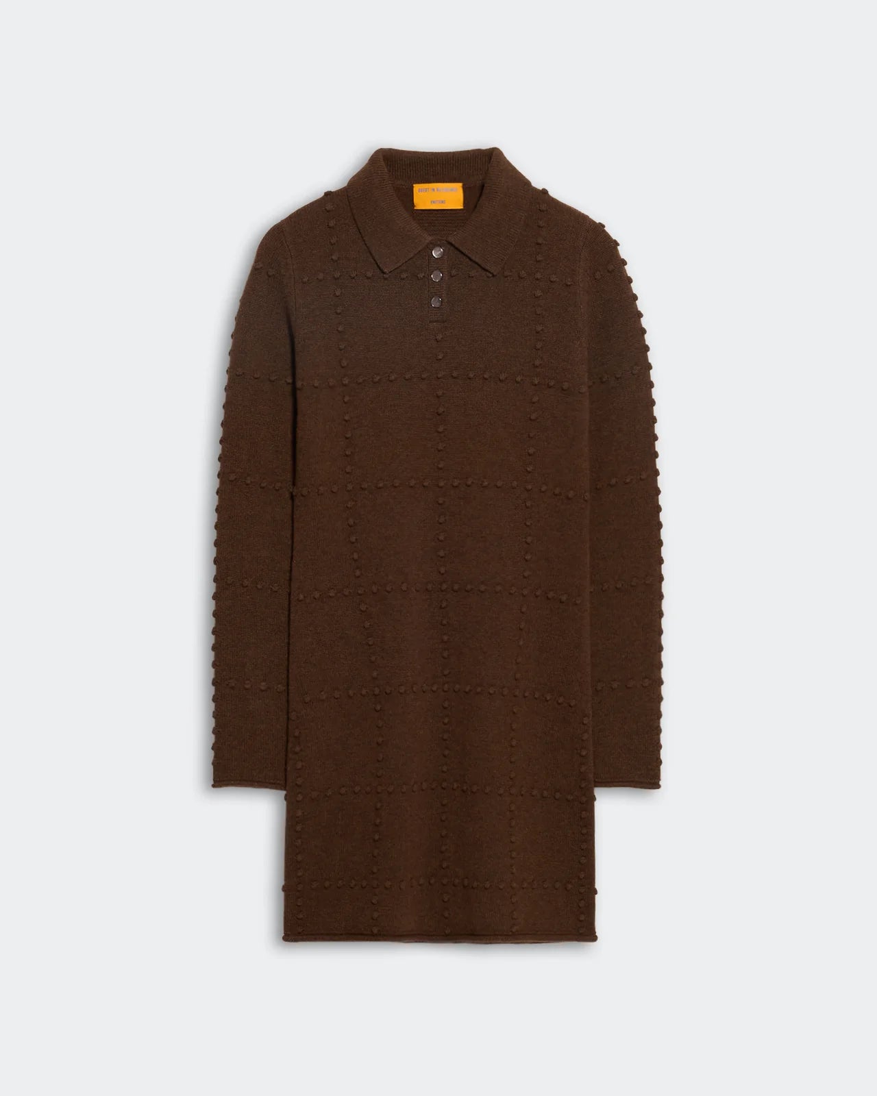 The Popcorn Polo Dress by Guest in Residence is a brown, long-sleeve women’s knit sweater dress with a collar, button placket, and textured grid pattern, shown laid flat on a plain light background.