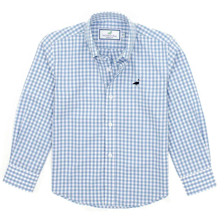 The Properly Tied Seasonal Sportshirt by Properly Tied is a light blue and white checkered button-up, made from a soft cotton blend. It features long sleeves, a small black logo on the chest, and a convenient pocket.