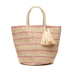 The Mar Y Sol Costa Tote features woven straw, two handles, subtle pink stripes, and beige tassel accents. Stylish and spacious, it’s ideal for carrying all your summer essentials.