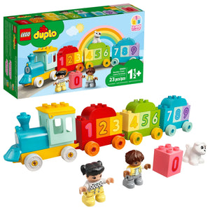 The LEGO® DUPLO® Number Train - Learn To Count is a colorful train with blocks 0–9, two child figures, a white dog, and packaging showing this fun toddler educational toy with a cheerful rainbow illustration.