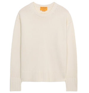 The Cozy Crew Cashmere Sweater by Guest in Residence features long sleeves, an off-white knit design, a cozy crew neckline, and ribbed neck trim, displayed on a white background.