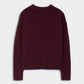 The Guest in Residence Cozy Crew Cashmere Sweater is a women’s long-sleeved, dark burgundy pullover featuring a classic crew neckline and ribbed cuffs and hem, shown laid flat on a light background.