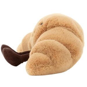 The Jellycat Amuseables Croissant, Small is a plush toy with a soft texture, featuring charming pastry knobbles and playful brown corduroy legs.