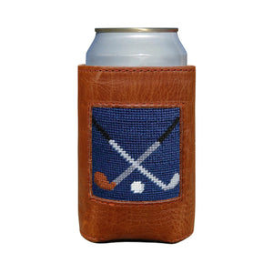 A can in the Smathers & Branson Crossed Clubs Can Cooler, a brown Italian leather sleeve featuring a blue patch with crossed clubs and a puck design.