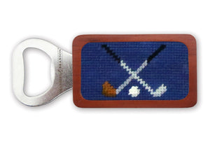 Smathers & Branson's Crossed Clubs Bottle Opener features a solid wood frame and blue fabric with hand-stitched needlepoint of crossed golf clubs and a golf ball.