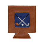 The Smathers & Branson Crossed Clubs Can Cooler pairs brown Italian leather with a stitched blue patch featuring two crossed hockey sticks and pucks, effortlessly blending classic style and the durable performance of premium neoprene.
