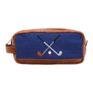 This Smathers & Branson Toiletry Bag is rectangular in shape and features a brown and blue color scheme with a hand-stitched needlepoint design depicting two crossed golf clubs and a golf ball on a tee.