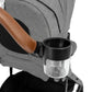 A Nuna stroller from the MIXX & Demi series featuring a brown leather handle and a transparent cup holder attached to it, known as the Nuna MIXX & Demi Cup Holder.