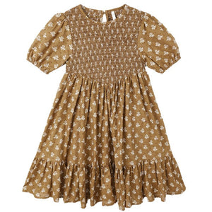 The Girls' Lydia Dress by Rylee & Cru is a brown, short-sleeve dress with a white floral print, shirred bodice, ruffled hem, and gathered skirt—an effortlessly chic smocked style for any occasion.