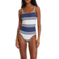 A woman wears the Lemlem Elene One Piece, a classic swimsuit with navy and white stripes, adjustable spaghetti straps, and an interior shelf bra for support.
