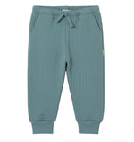 The Cozmo Baby Boys’ Daan Quilted Sweatpant features a ribbed blue-green design with an elastic waistband, drawstring, side pockets, and cuffed ankles for a comfortable fit, displayed flat against a white background.