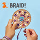 Two hands expertly weave colorful threads on an heirloom-quality wooden disc against a blue backdrop. The number "3" and "Braid!" in bold orange highlight the innovative design of the Bright Stripes Dial-A-Design Bracelet Wheel.