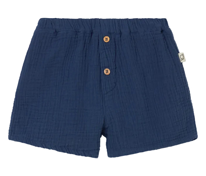 The Cozmo Baby Boys' Dale Shorts feature navy blue textured gauze, an elastic waistband, two wooden front buttons, and a side fabric tag—stylish and comfy toddler shorts.