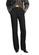 Heidi Trouser in black twill with a high-waisted, straight-leg fit, worn with a textured cardigan.