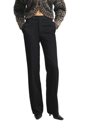 Heidi Trouser in black twill with a high-waisted, straight-leg fit, worn with a textured cardigan.