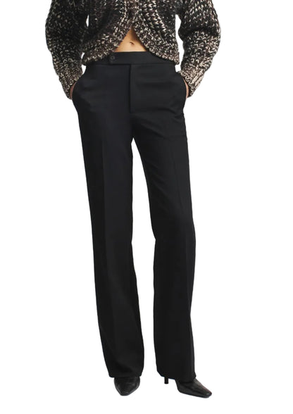 Heidi Trouser in black twill with a high-waisted, straight-leg fit, worn with a textured cardigan.