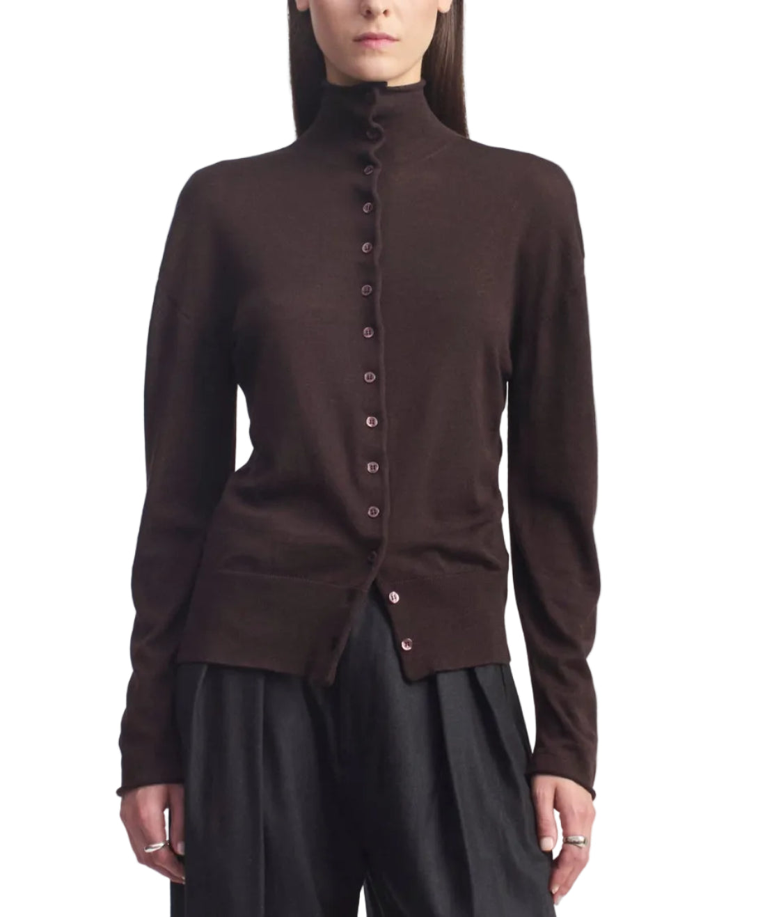 A person wearing the Kallmeyer Leona Silk Wool Cardigan in chocolate brown, featuring a button-up front and funnel collar, paired with black pants and standing against a white background.