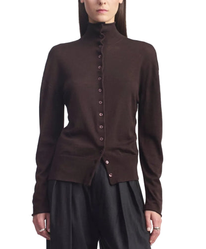 A person wearing the Kallmeyer Leona Silk Wool Cardigan in chocolate brown, featuring a button-up front and funnel collar, paired with black pants and standing against a white background.