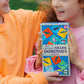 Two children hold a box of Eeboo’s Giant Shiny Shark Dominoes, a colorful kids’ game with vibrant shark illustrations—ideal for family fun and matching play.