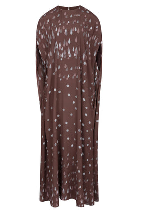 The Eleonore Polka Rain Dress by Bernadette is a long, loose brown crepe de chine dress featuring white polka rain and teardrop patterns, shown on a plain background.