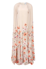 The Minnie Poppies Dress by Bernadette is a long beige cape gown featuring a high neckline, flowing silhouette, and red, pink, and white floral print along the lower half and hem.