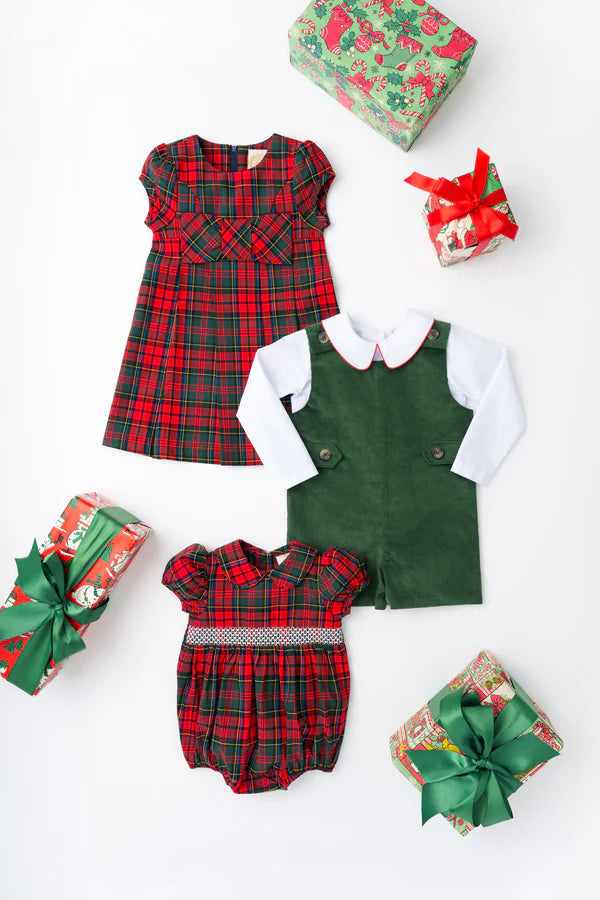 Three wrapped gifts and three children's holiday outfits—including The Beaufort Bonnet Company Girls' Darcy Dress, a green romper with white shirt, and a red plaid baby romper—are arranged on a white background.