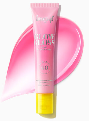 A pink tube of Supergoop Glow Gloss Lip Balm SPF 40 is shown with a swatch behind it on a white background, ideal for ultra-hydrated lips and a non-sticky finish.