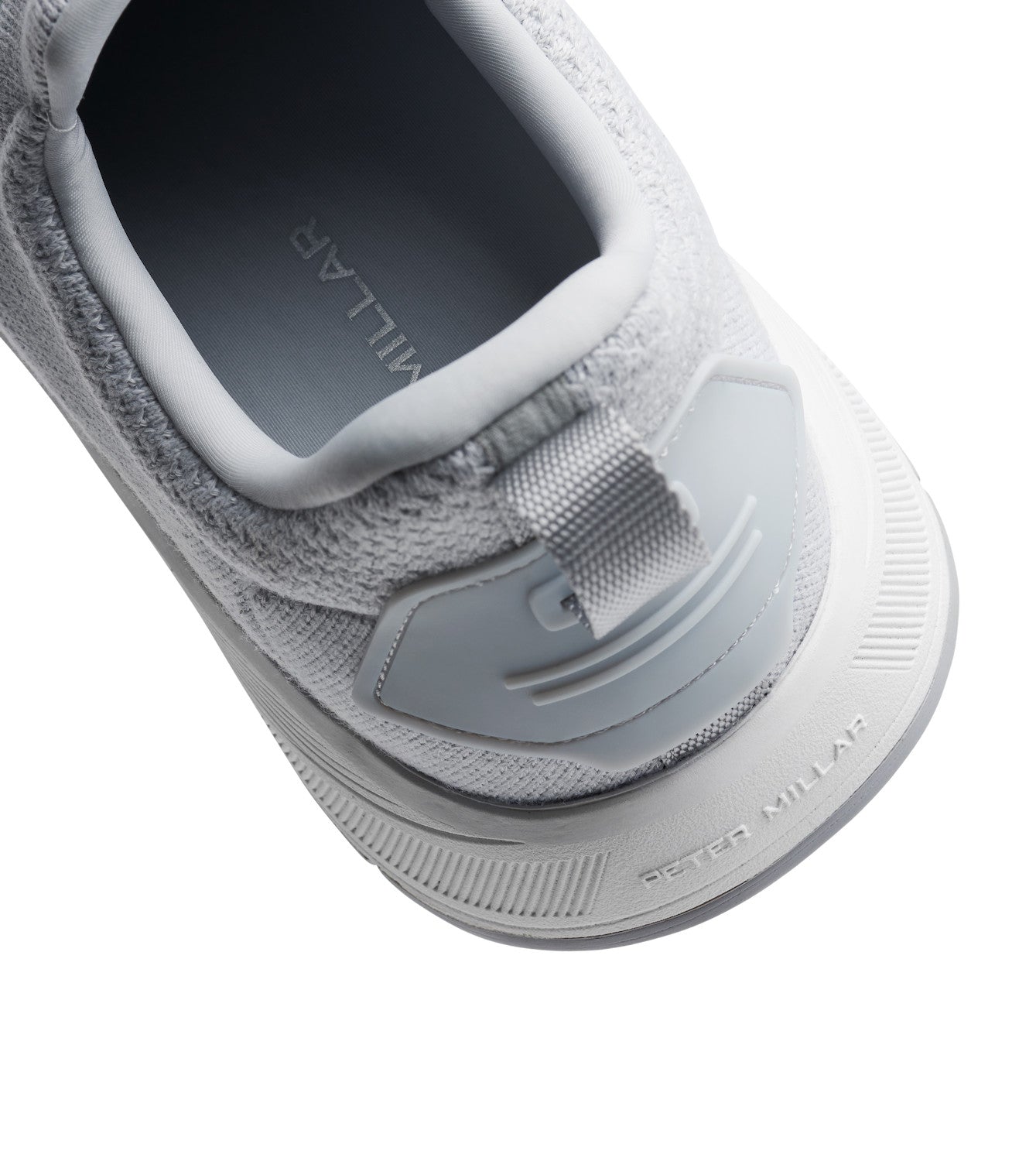 Close-up of the Peter Millar Tellustride Sneaker in gray, showcasing a textured knit design, a label on the heel, and equipped with a plush memory foam insole for enhanced comfort.