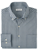 The Peter Millar Prairie Performance Twill Sport, a long-sleeve shirt in blue and white checkered pattern with a button-down collar, includes a label inside the neck and provides UPF 50+ sun protection for enhanced safety in the sun.