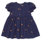 Pink Chicken Girls' Eliza Eyelet Embroidery Dress in navy features short puffed sleeves, delicate floral embroidery, eyelet details, and button closure down the back. Displayed on a plain background, this charming dress is perfect as a fall outfit for girls for any occasion.