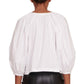 The back view of a woman wearing a Staud Dill Top blouse and leather pants.