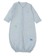 The Kissy Kissy Dinosaur Domain Striped Convertible Gown features long sleeves and is crafted from soft Pima cotton. It showcases blue, white, and yellow stripes with embroidered dinosaur patches and a convenient front zipper closure for easy changes.