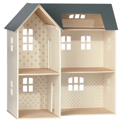 Introducing the Maileg Dollhouse, House of Miniature with Wallpaper: a charming wooden dollhouse featuring an open back design, three spacious floors, multiple rooms adorned with patterned wallpaper, and a dark gray roof. Complete this enchanting abode with Maileg miniature furniture for a magical touch.