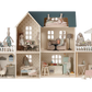 The delightful Maileg Dollhouse, House of Miniature with Wallpaper, is fully furnished with Maileg's exquisite miniature furniture and decor. It features charming rabbit dolls in various rooms, engaging in activities such as cooking, reading, and sleeping.