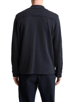 Seen from behind, a person wears dark pants and the Vince Double Slub Shirt Jacket—a collar style with buttoned cuffs, crafted from premium cotton lyocell for ultra-soft comfort.