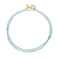 Introducing the Jane Win Double Wrap Beaded Necklace—a delicate, double-stranded light blue beaded piece featuring a gold clasp and a small round gold charm. Perfect for pairing with your favorite versatile necklace or Jane Win pendant.