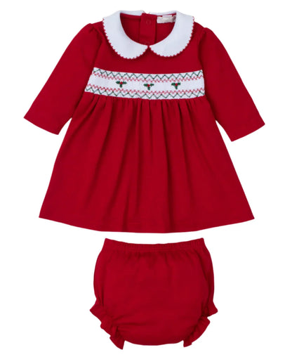 The Kissy Kissy CLB Holiday Medley 24 Red Hand Smocked Mistletoe Dress Set features a red baby holiday dress with a white collar and decorative stitching, made from soft Pima cotton. This delightful outfit is completed with matching red bloomers.