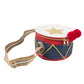 The Meri Meri Drum Bag by Meri Meri is a drum-shaped accessory with a vibrant red, white, and blue color scheme adorned with a star on top and red pom-poms. It features a beige-striped shoulder strap, making it an ideal complement to your Nutcracker costume or for stylishly carrying your wooden drumsticks.