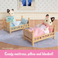 Two Calico Critters cat figures rest in the Stack and Play Beds by Calico Critters, complete with comfy mattresses, pillows, and blankets. The cozy dollhouse bedroom features a window and a blue rug. Text at the bottom says, “Comfy mattress, pillow and blanket!”.