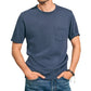 Man wearing the Faherty Sunwashed Pocket Tee in blue, crafted from organic cotton for a relaxed silhouette, hands in jeans pockets with bracelets on his right wrist, isolated on white background.